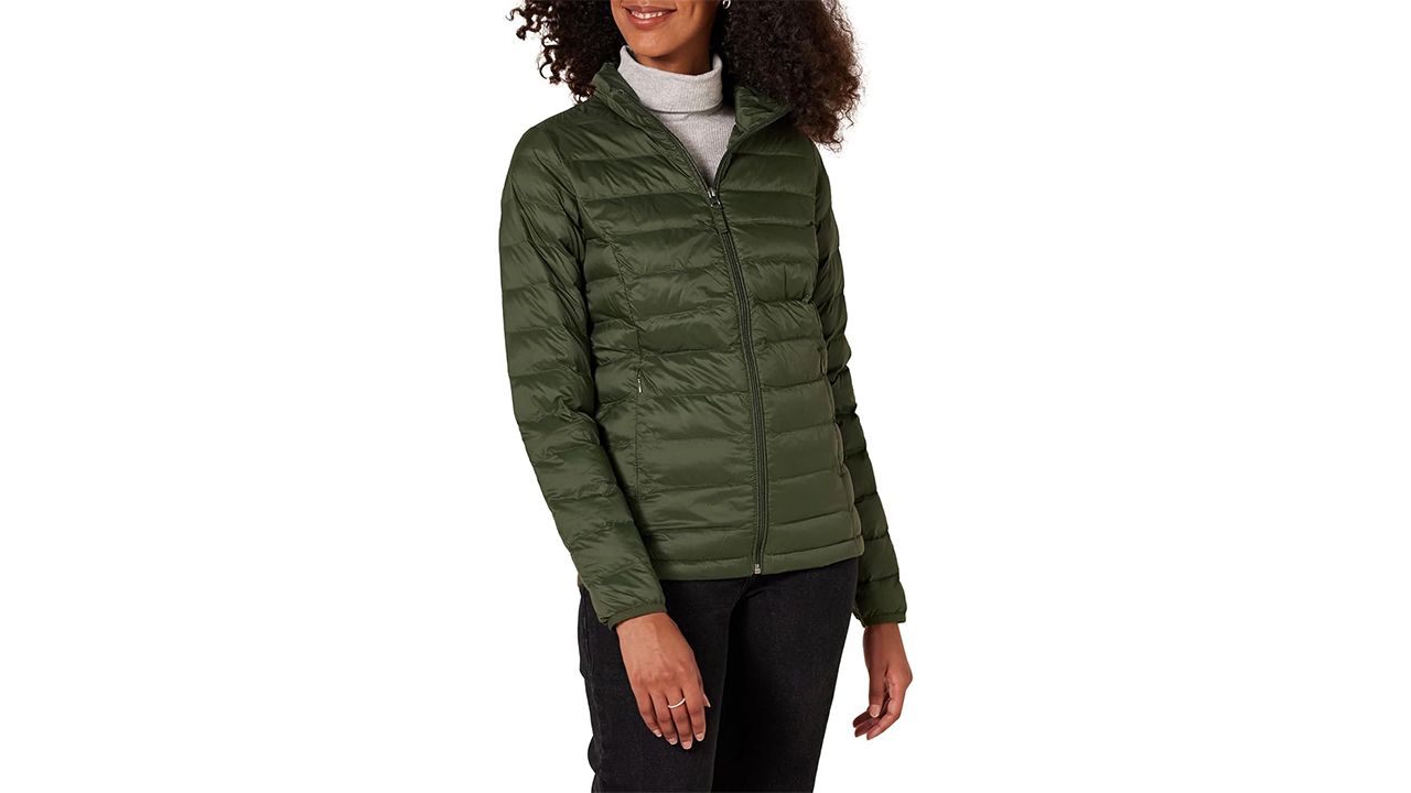 A photo of a person wearing the Amazon Basics Packable Puffer Jacket n green