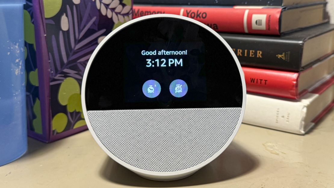 An Amazon Echo Spot's alarm is going off at 3:12pm with the text "Good afternoon!" and icons for Snooze and Stop