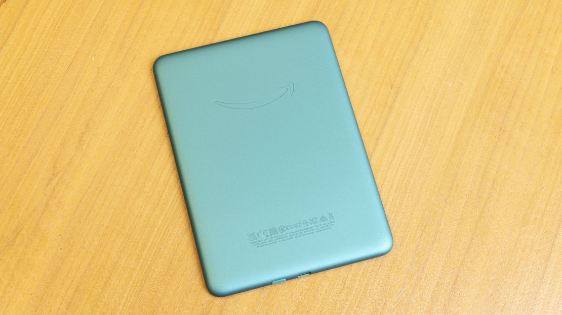 The Amazon Kindle Paperwhite is face down on a table showing its Jade green back