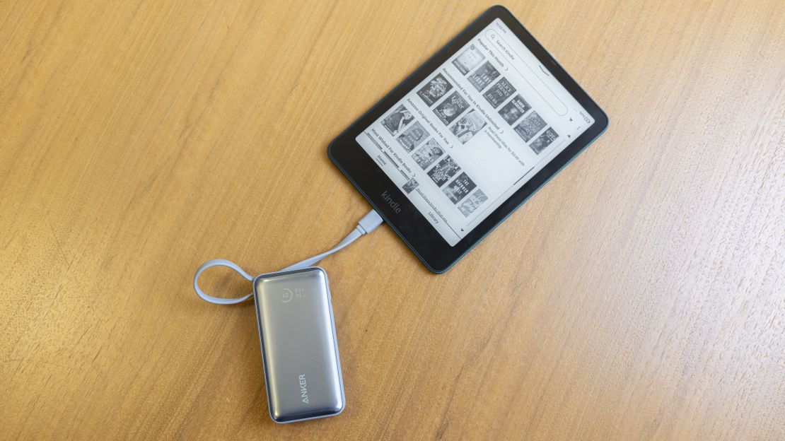 The Amazon Kindle Paperwhite 2024, plugged into an Anker Nano Power Bank charger.