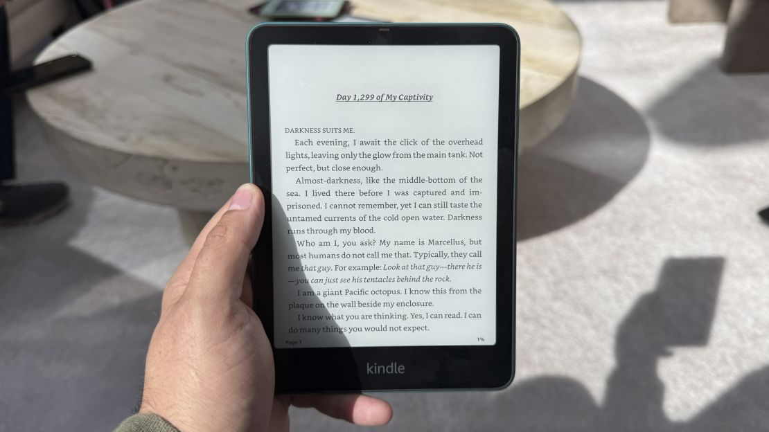 The Amazon Kindle Paperwhite (2024) is held in the air