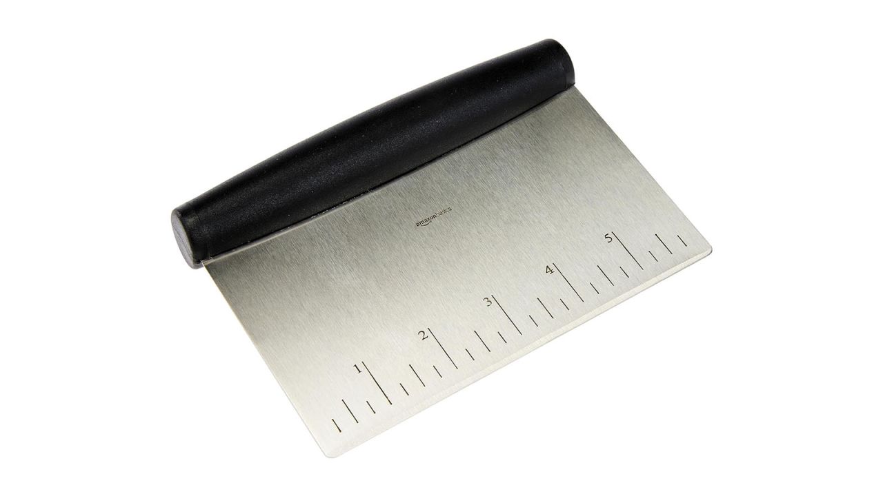 Stainless steel scraper placed against white background.