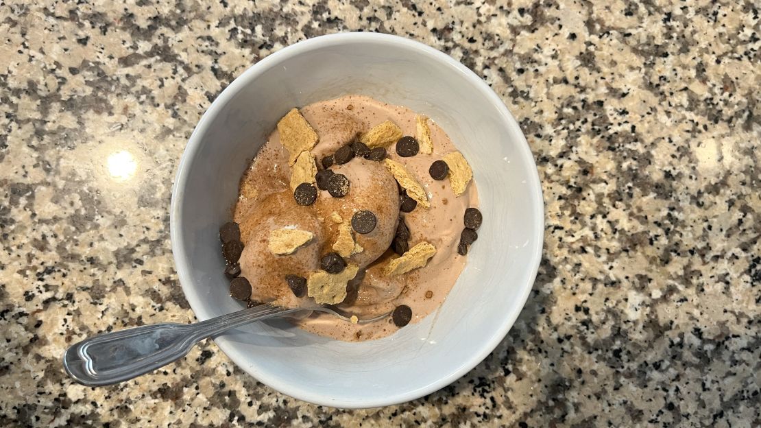 Chocolate protein ice cream topped with chocolate chips and graham crackers.