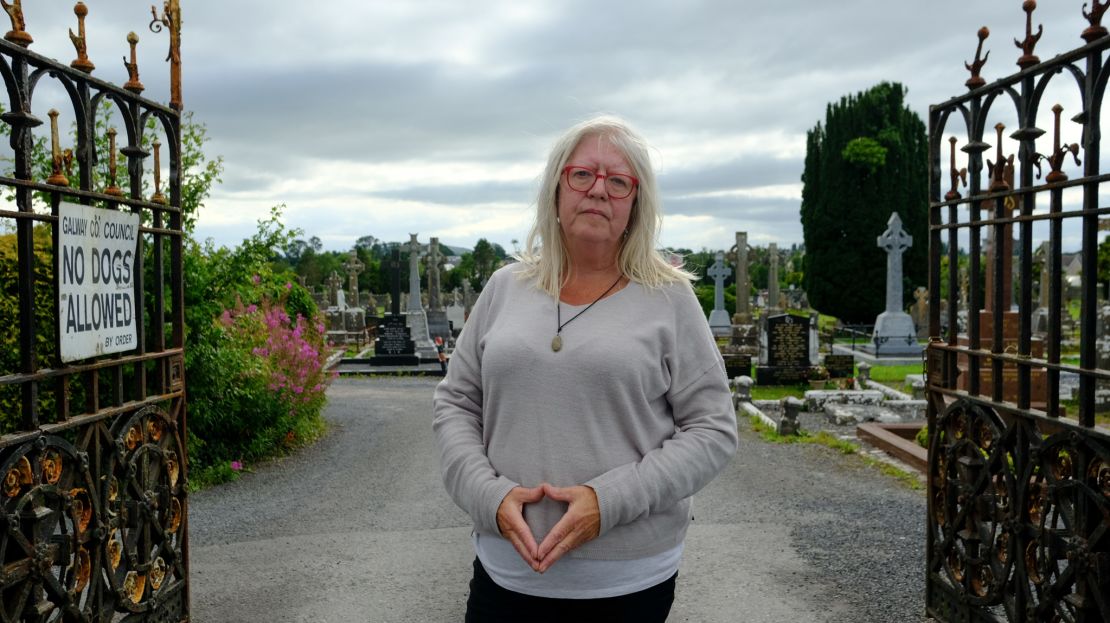 Anna Corrigan, whose brothers were born in the former Tuam mother and baby home, stands at a graveyard located just three minutes from the site.