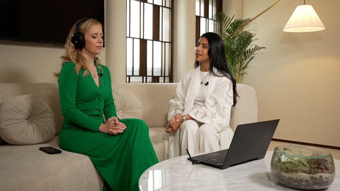 CNN’s Anna Stewart tries an early iteration of Neurable’s MW75 Neuro headphones with Deena Al Jassasi (right) at Healthspan Digital, a longevity clinic in Dubai.