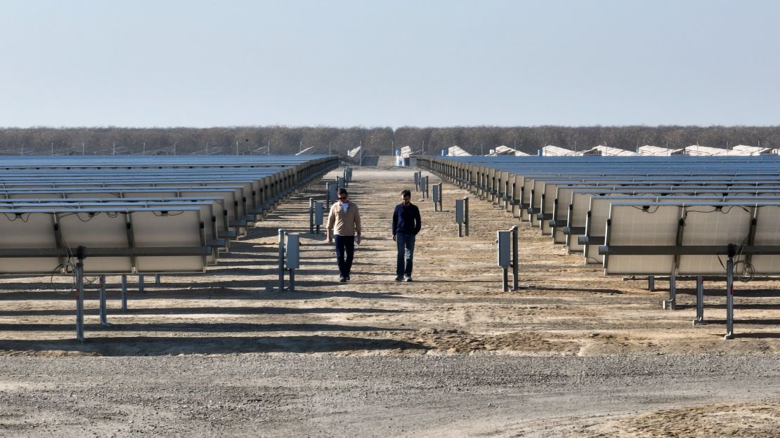 Bill (left) walks through a solar array with Antora Energy's co-founder and CEO. The company is developing new ways to store clean energy.