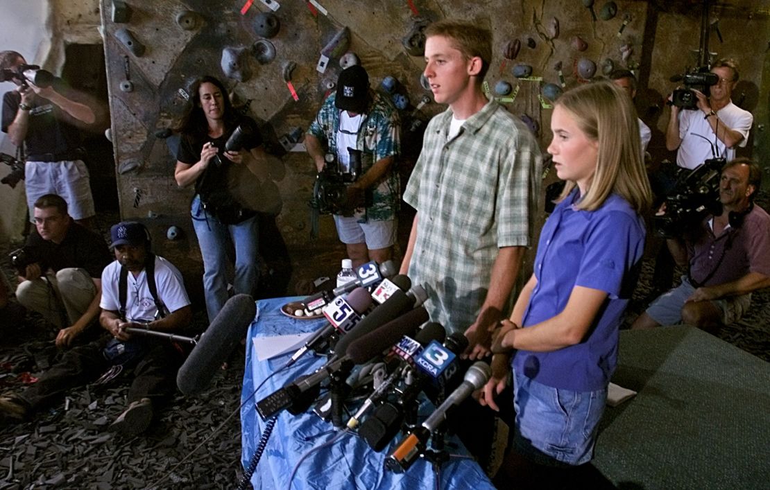 Tommy Caldwell, left, and Beth Rodden are surrounded by the media as they talk about their ordeal after they were taken captive, during a news conference held in Davis, California on August 24, 2000.