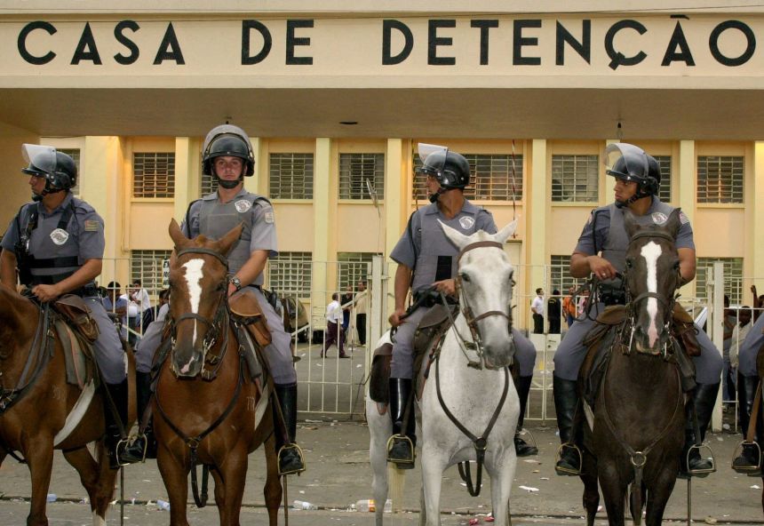 Brazilian Mounted Police stand guard outside Carandil Prison in Sao Paulo, Brazil, on February 18, 2001. Riots spread to other prisons in the area, with rioting prisoners taking guards and visitors hostage.