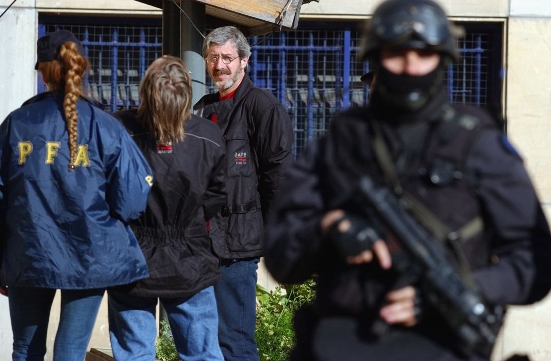 Bertulazzi, second right, and an unidentified woman, second left, are escorted by agents inside Argentine federal court on November 4, 2002.