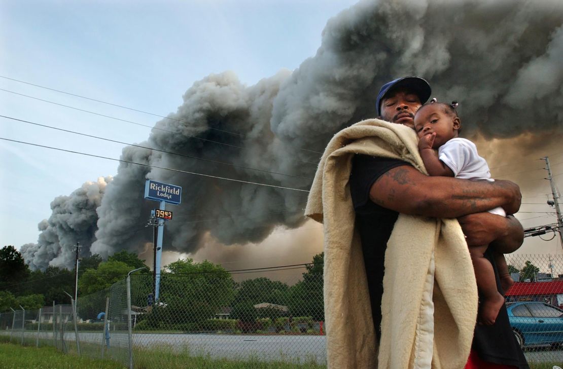 Darryl Brown, 32, and his 5-month-old daughter Alicia evacuated from the Richfield Lodge in Conyers after a massive fire at the BioLab facility on May 25, 2004.