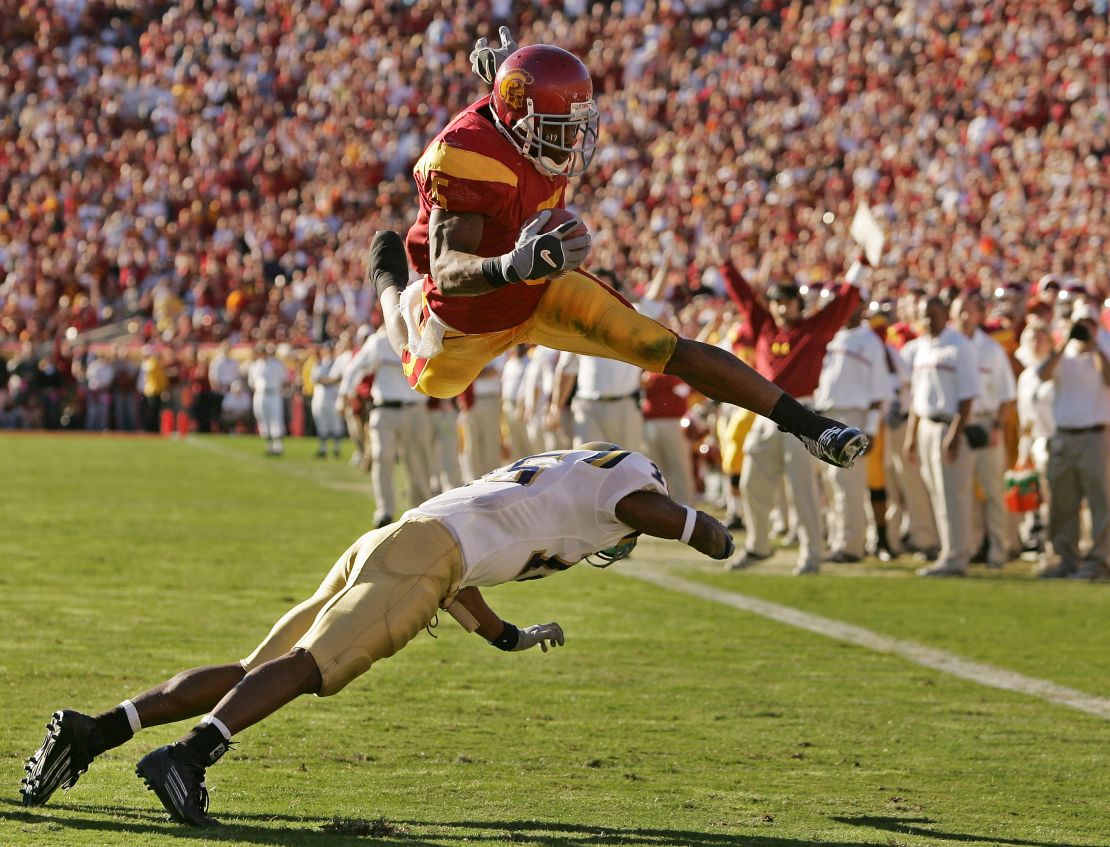 Bush leaps over UCLA defender Marcus Cassel during his time as a USC Trojan at the Los Angeles Memorial Coliseum, December 3, 2005.