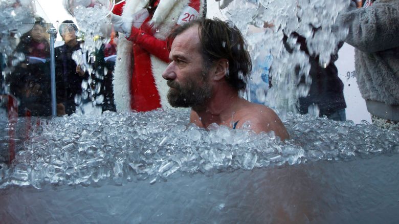 In this 2010 photo, Wim Hof of the Netherlands immerses in ice water during a performance in Hong Kong.