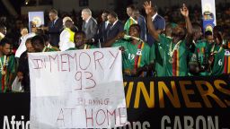 Zambia's players hold a banner in memory of the 1993 plane crash that killed the Zambia team in Gabon, as they celebrate their victory of the African Cup of Nations after their final soccer match against Ivory Coast at Stade de l'Amitie in Libreville, Gabon, Sunday, Feb. 12, 2012. (AP Photo/Francois Mori)