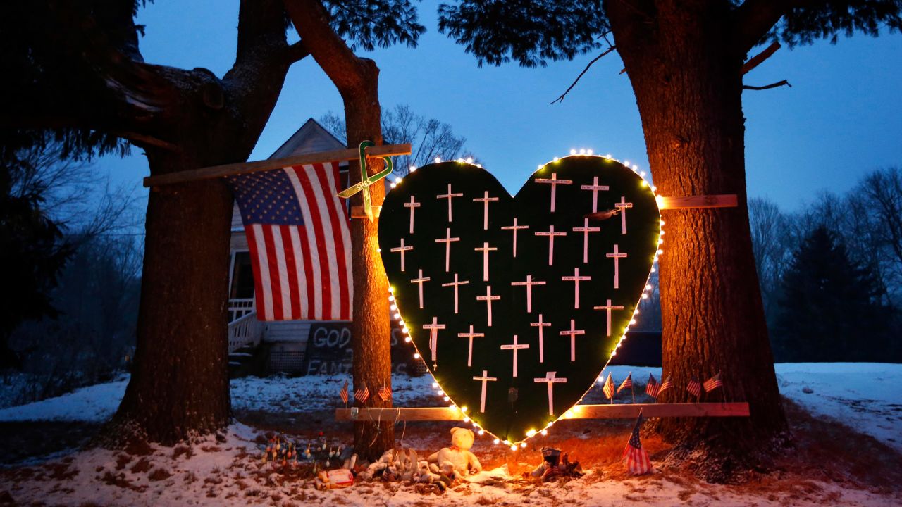 In this December 2013 file photo, a makeshift memorial with crosses for the victims of the Sandy Hook Elementary School shooting massacre stands outside a home in Newtown, Conneticut, on the one-year anniversary of the shootings.