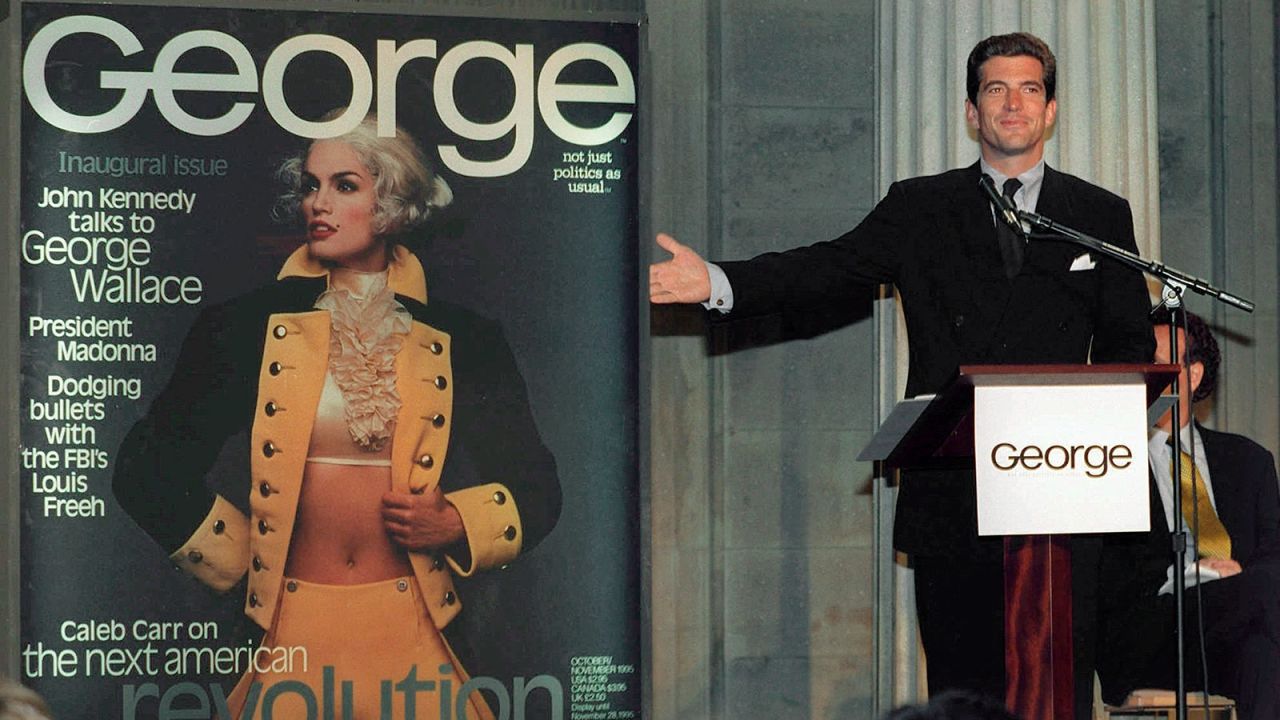 FILE - In this Sept. 7, 1995 file photo, John F. Kennedy Jr., co-founder and editor-in-chief of the politics-as-lifestyle George magazine, unveils the magazine's first cover in New York. A documentary film on John Kennedy Jr.'s life opens Friday, July 22, 2016, in select theaters. It also airs on Spike TV at 9 p.m. EDT on Aug. 1, and a DVD release is set for Aug. 16. (AP Photo/Marty Lederhandler, File)