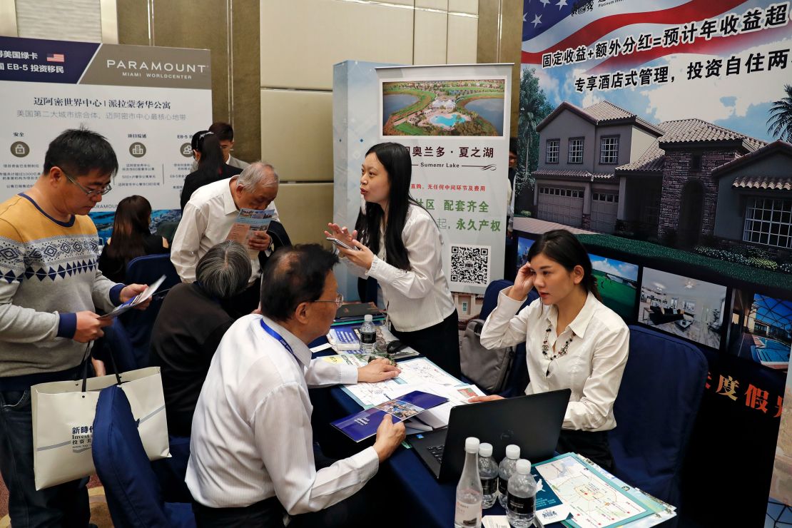 Chinese visitors seek information on the US government's EB-5 visa program at a 2017 Invest in America Summit in Beijing.