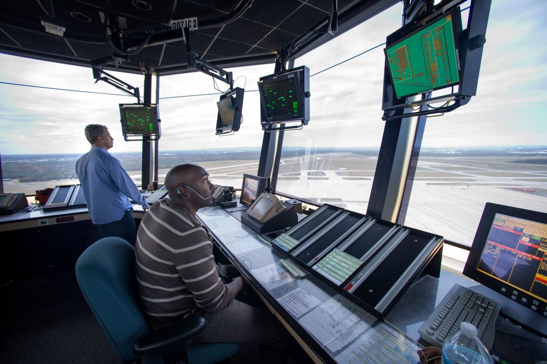 FAA air traffic controllers work in the tower at Dulles International Airport in Sterling, Virginia.