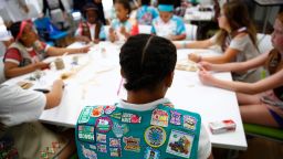 In this July 21, 2017 photo, badges are seen on the vest of a member of the Girl Scouts of Central Maryland as Girl Scouts participate in an activity introducing them to the world of robotics in Owings Mills, Md.