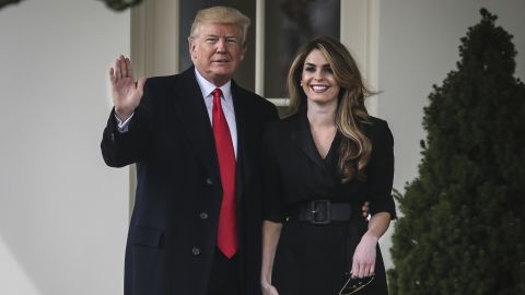 Then-President Donald Trump stands next to Hope Hicks before boarding Marine One on the South Lawn of the White House on March 29, 2018, in Washington.