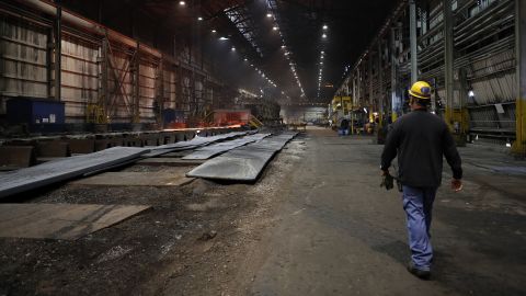In this June 28, 2018, file photo, a worker walks inside the hot-strip mill at the U.S. Steel Granite City Works facility in Granite City, Illinois.