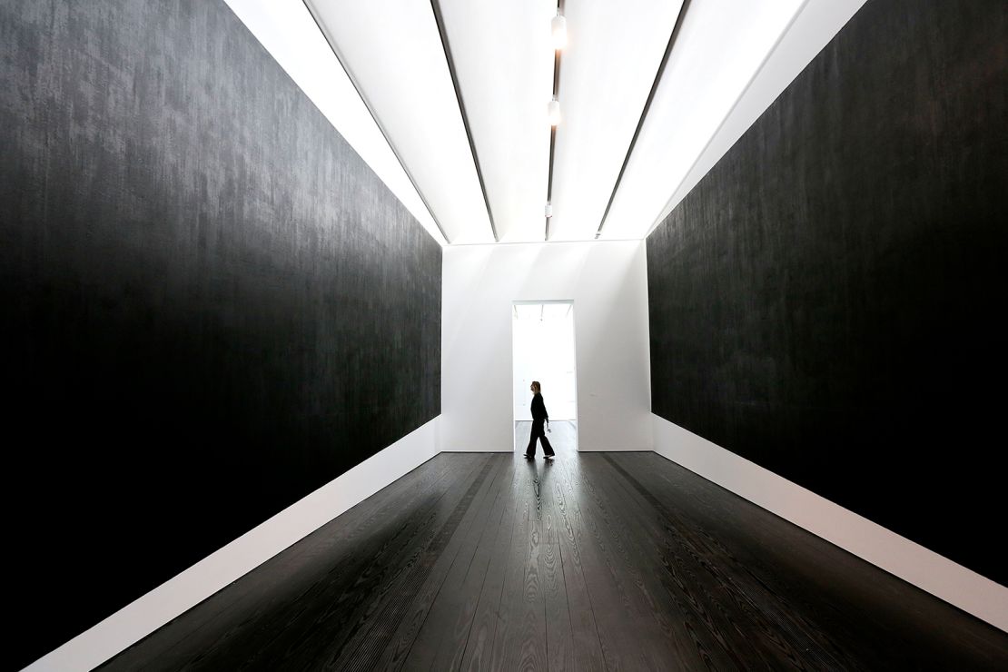 A museum employee walks through Richard Serra's "Two Corner Cut: High Low" at the Menil Collection in Houston, Texas.