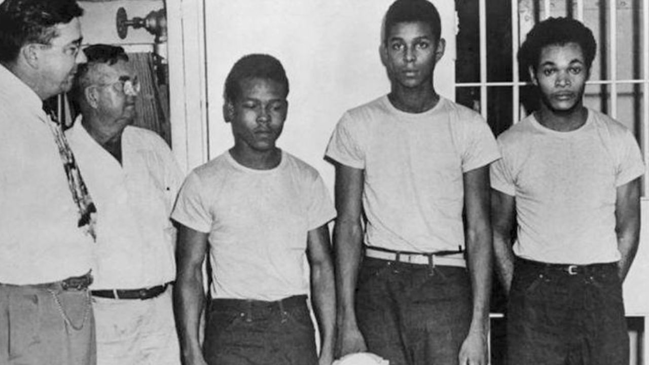 Lake County Sheriff Willis McCall, far left, and an unidentified man stand next to Walter Irvin, Samuel Shepherd and Charles Greenlee, from left, in Florida. The three men along with a fourth were charged with rape in 1949.