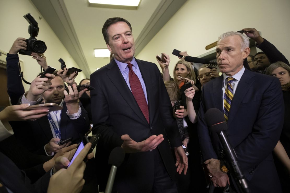 Former FBI Director James Comey, with his attorney, David Kelley, right, speaks to reporters on Capitol Hill in Washington, December 7, 2018.