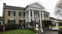 This March 13, 2017 photo shows visitors getting ready to tour Graceland in Memphis, Tenn.  The head of the company that controls Graceland says he is not threatening to move the Memphis, Tennessee-based tourist attraction centered on the life of singer Elvis Presley if city officials do not approve an expansion plan including tax-based incentives.  (AP Photo/Beth J. Harpaz, File)