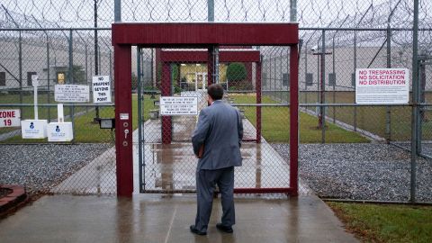 Attorney Matt Boles, 27, with the Southern Poverty Law Center's Southeast Immigrant Freedom Initiative, heads to immigration court at the Stewart Detention Center, Friday Nov. 15, 2019, in Lumpkin, Ga. Visitors to the immigration court pass through two sliding gates set into chain link fencing topped by loops of razor wire, the first gate closing behind them before the second opens. "When you go to court, it's not very welcoming because of the security measures. It's in so many ways a reminder of why I want to win so badly," says Boles. "I think that walking into that environment reinforces the desire to give hope to people and get them free to be with their families." (AP Photo/David Goldman)
