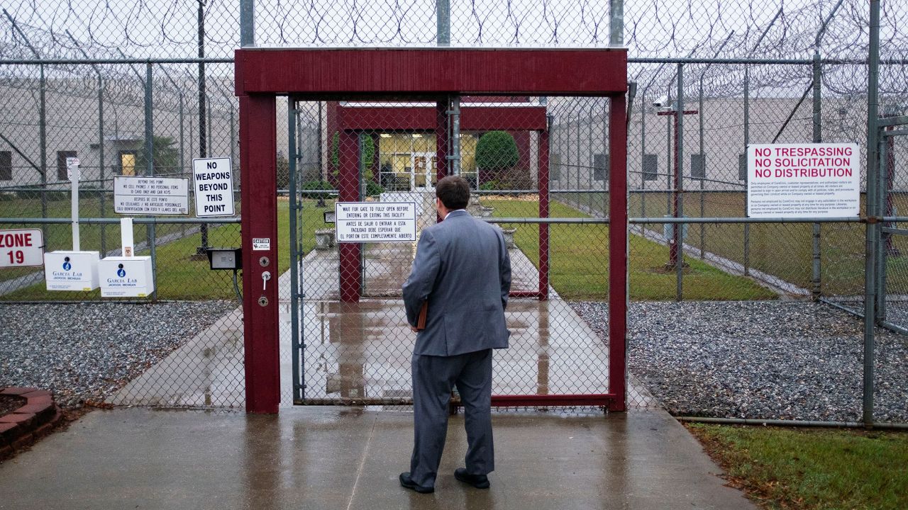 Attorney Matt Boles, 27, with the Southern Poverty Law Center's Southeast Immigrant Freedom Initiative, heads to immigration court at the Stewart Detention Center, Friday Nov. 15, 2019, in Lumpkin, Ga. Visitors to the immigration court pass through two sliding gates set into chain link fencing topped by loops of razor wire, the first gate closing behind them before the second opens. "When you go to court, it's not very welcoming because of the security measures. It's in so many ways a reminder of why I want to win so badly," says Boles. "I think that walking into that environment reinforces the desire to give hope to people and get them free to be with their families." (AP Photo/David Goldman)