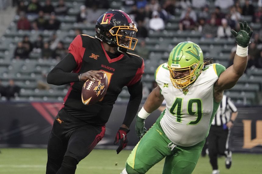 Johnson (left) played a season in the XFL with the LA Wildcats.