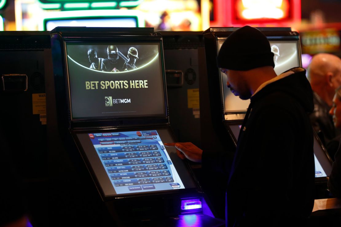 A gambler enters his bet during the launch of legalized sports betting in Michigan at the MGM Grand Detroit casino in Detroit, Wednesday, March 11, 2020.