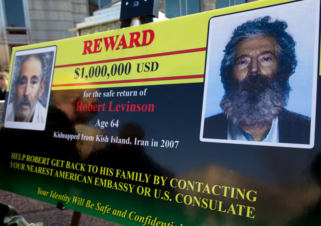An FBI poster shows a photo of Levinson taken from captors' video and a composite image of how he would have looked in 2012, five years into captivity. His family learned of his death in 2020.