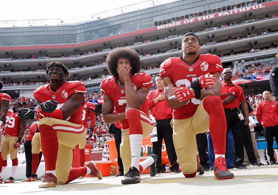 San Francisco 49ers players Eli Harold, left, Colin Kaepernick and Eric Reid kneel during the national anthem before an NFL game in Santa Clara, California, on October 2, 2016.