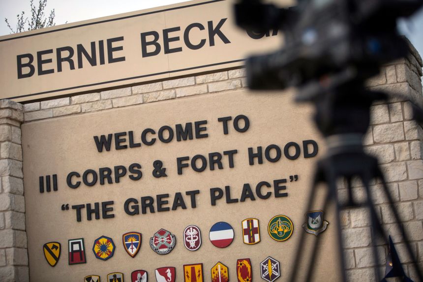 Members of the media wait outside of the Bernie Beck Gate, an entrance to the Fort Hood military base in Fort Hood, Texas in April 2014.