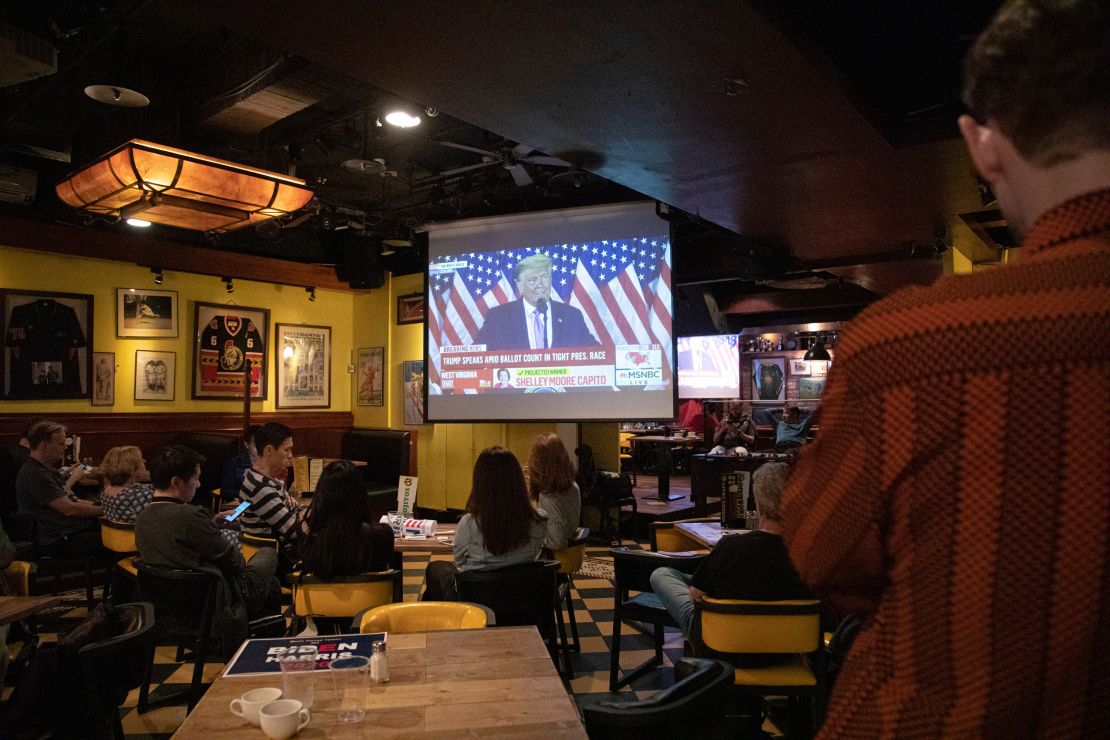 People in a Taipei bar watch former president Donald Trump speaking after he was defeated by Joe Biden in the 2020 presidential election. Four years later, both men will again go head-to-head in November's election.