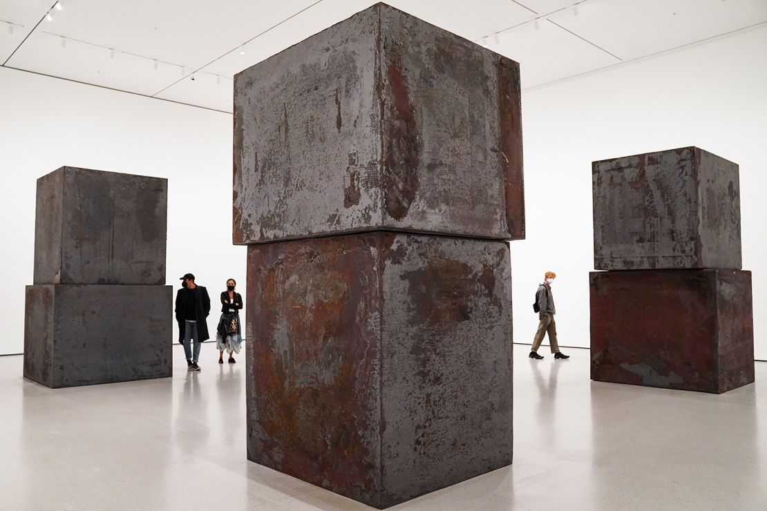 Museum visitors walk among the cubic forms of Serra's sculpture "Equal" at the Museum of Modern Art in New York in 2020.