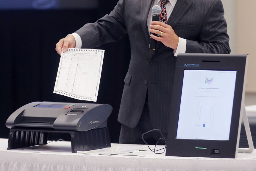 A Smartmatic representative demonstrates the company's voting system.