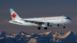 An Airbus A320 (A320-200) jetliner, belonging to Air Canada, lands in Calgary, Alberta on Jan. 9, 2021. In the background are the Rocky Mountains. (Larry MacDougal via AP)