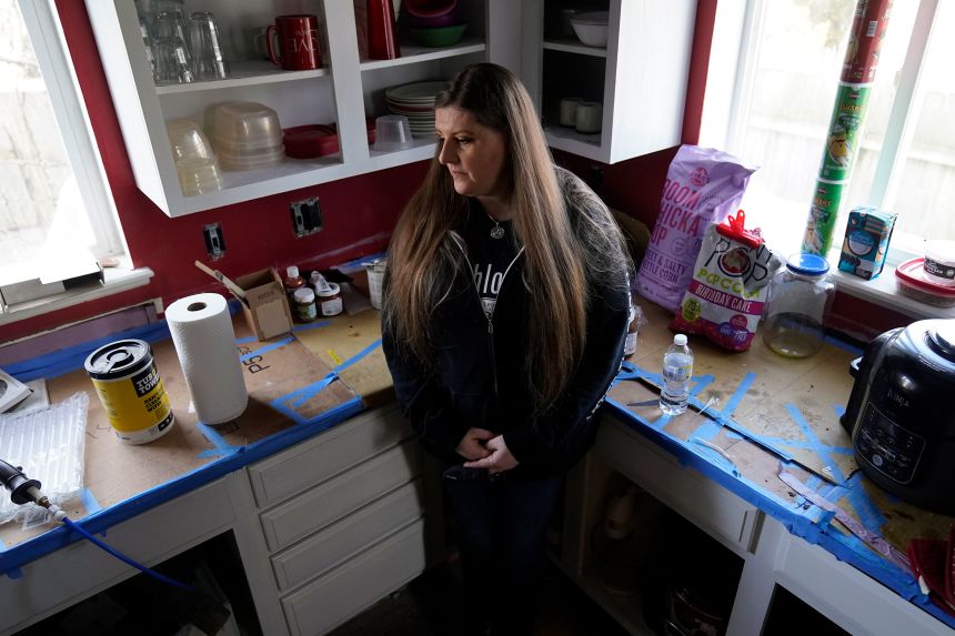 Melissa Mays stands in the kitchen of her home in Flint, Michigan, January 13, 2021.