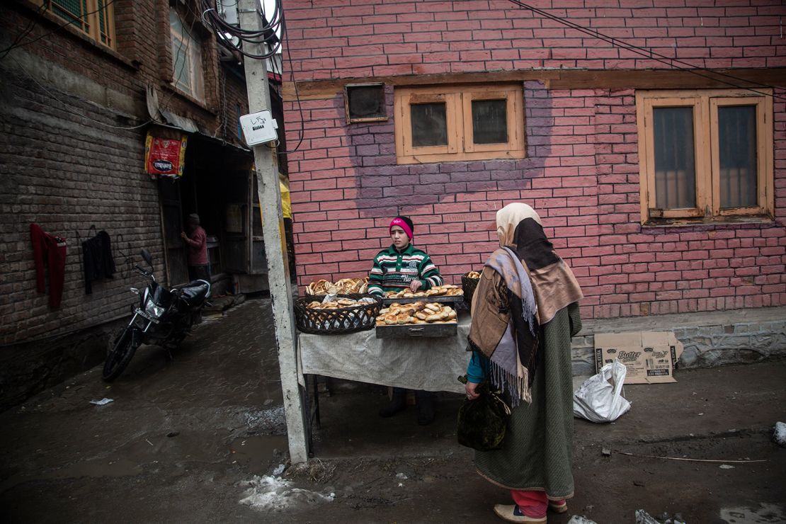 A boy sells breads at a street stall in Kashmir.