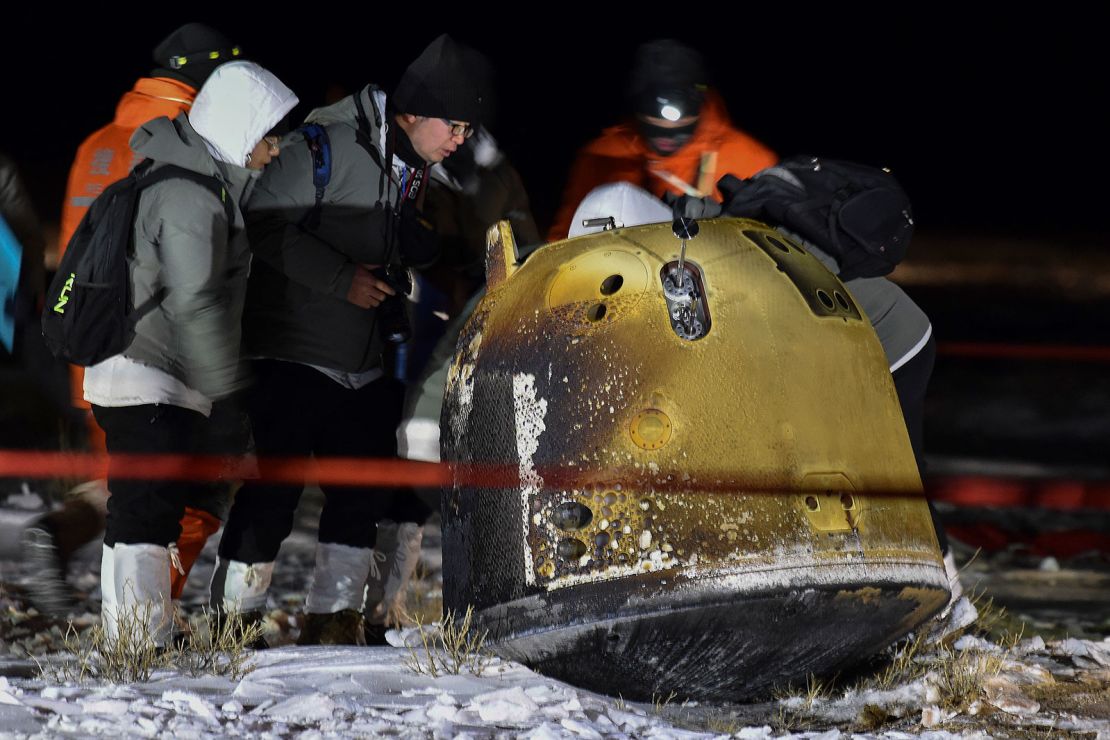 Recovery crew members inspect the Chang'e 5 probe after its successful return landing in northern China in December 2020.