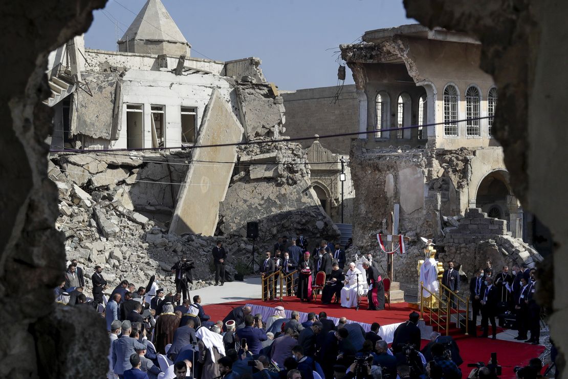 Pope Francis leads a prayer for war victims, surrounded by shells from a destroyed church, on March 7, 2021, in Hosh al-Biea church square in Mosul, Iraq, once the de facto capital of ISIS. Francisco.