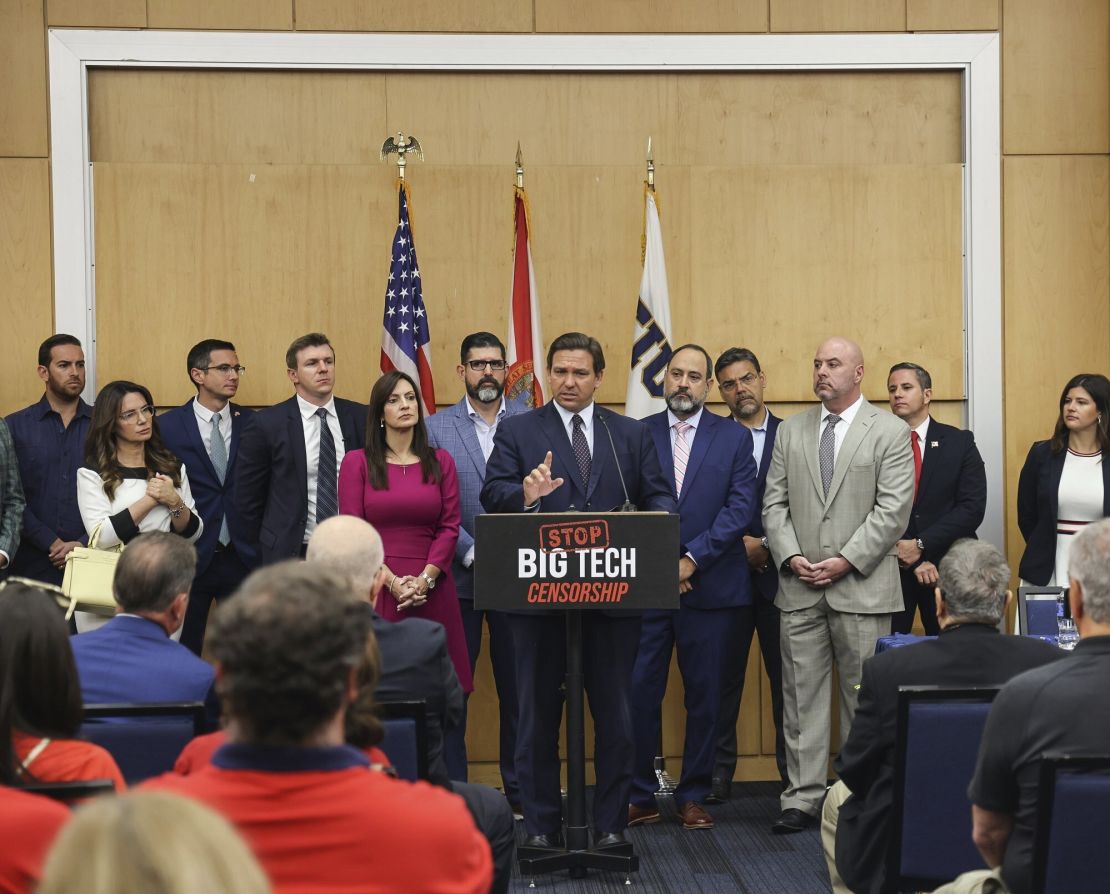 Florida Gov. Ron DeSantis, center, gives his opening remarks flanked by local state delegation members prior to signing legislation that seeks to punish social media platforms that remove conservative ideas from their sites, inside Florida International University's MARC building in Miami on Monday, May 24, 2021.