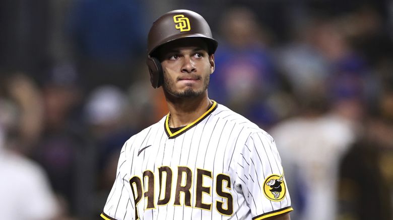 San Diego Padres' Tucupita Marcano walks back to the dugout after striking out with the bases loaded to end the fourth inning of a baseball game against the New York Mets Saturday, June 5, 2021, in San Diego. (AP Photo/Derrick Tuskan)