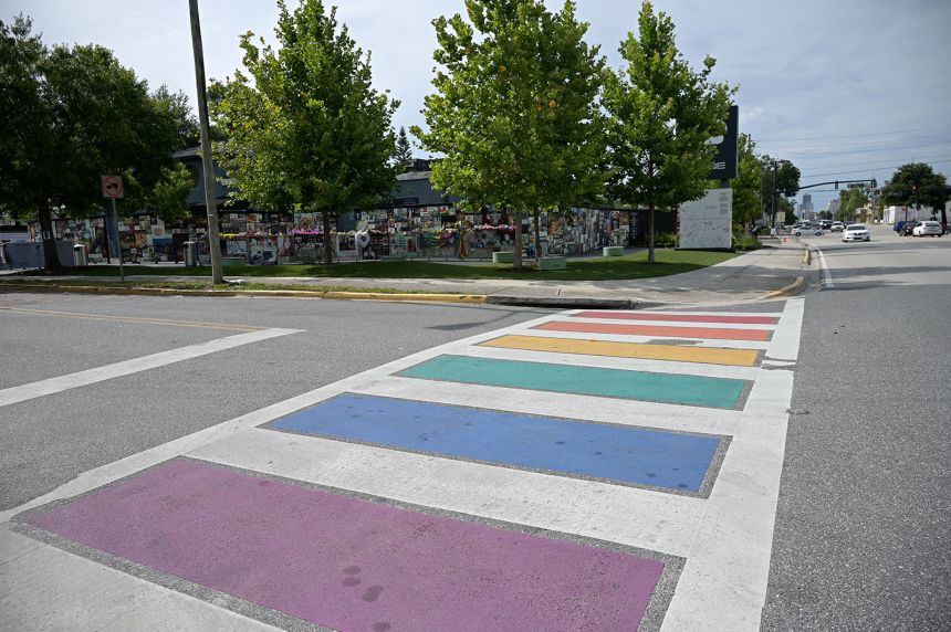 In a photo from 2021, the crosswalk painted in Pride colors in front of the of the onePULSE Foundation's Pulse Interim Memorial, honoring victims of the nightclub shooting.