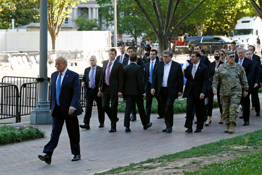 In this June 1, 2020, file photo, President Donald Trump walks in Lafayette Park to visit outside St. John's Church across from the White House in Washington.