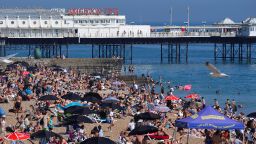 People enjoy the sunshine on Brighton beach, south east England, Wednesday June 16, 2021. (Aaron Chown/PA via AP)