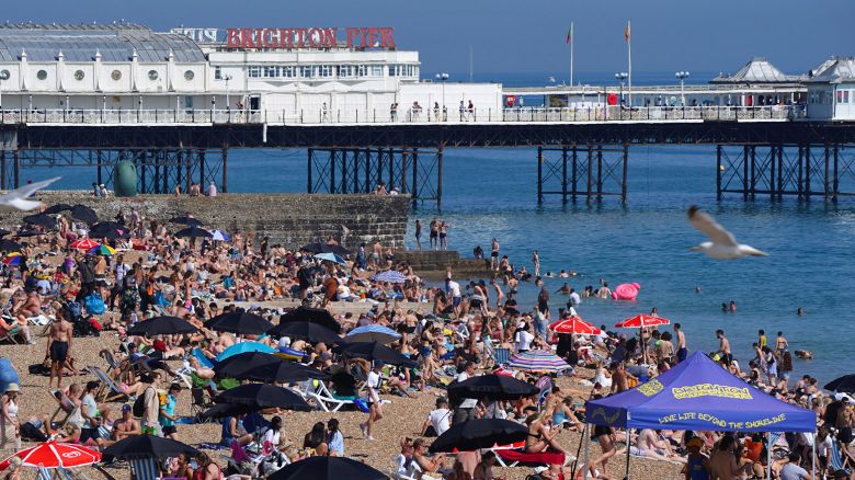 People enjoy the sunshine on Brighton beach, south east England, Wednesday June 16, 2021. (Aaron Chown/PA via AP)