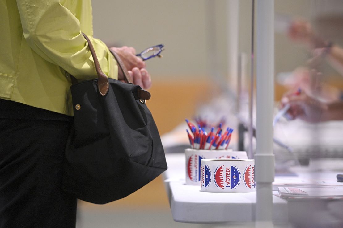 A poll clerk assists a voter to register at a polling station set up inside The Metropolitan Museum of Art on New York's Primary Election Day, in New York, NY, June 22, 2021.